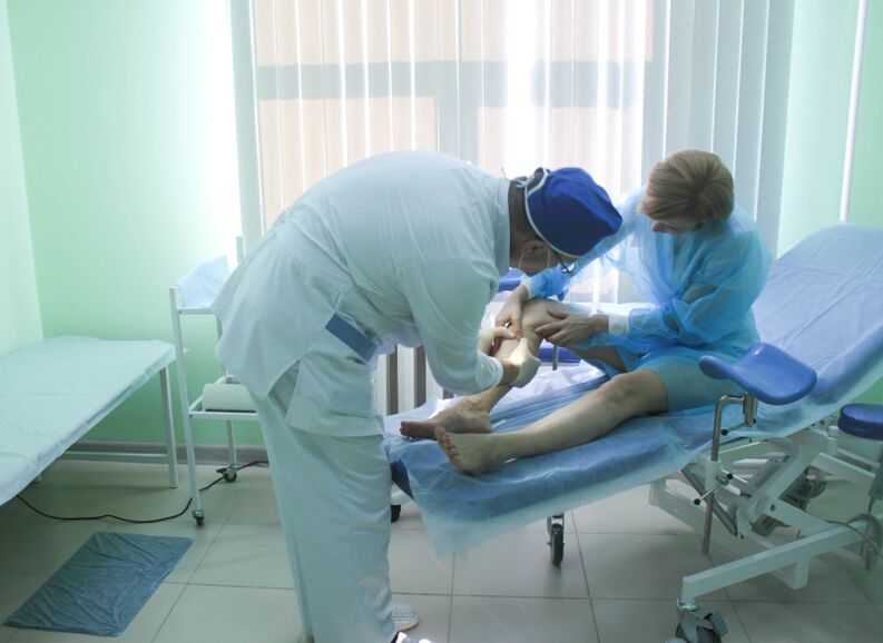 The surgeon checks the patient's veins before operating.